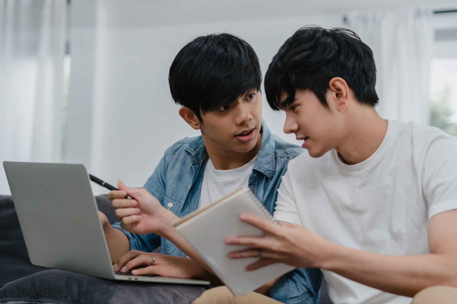 young asian students studying on laptop