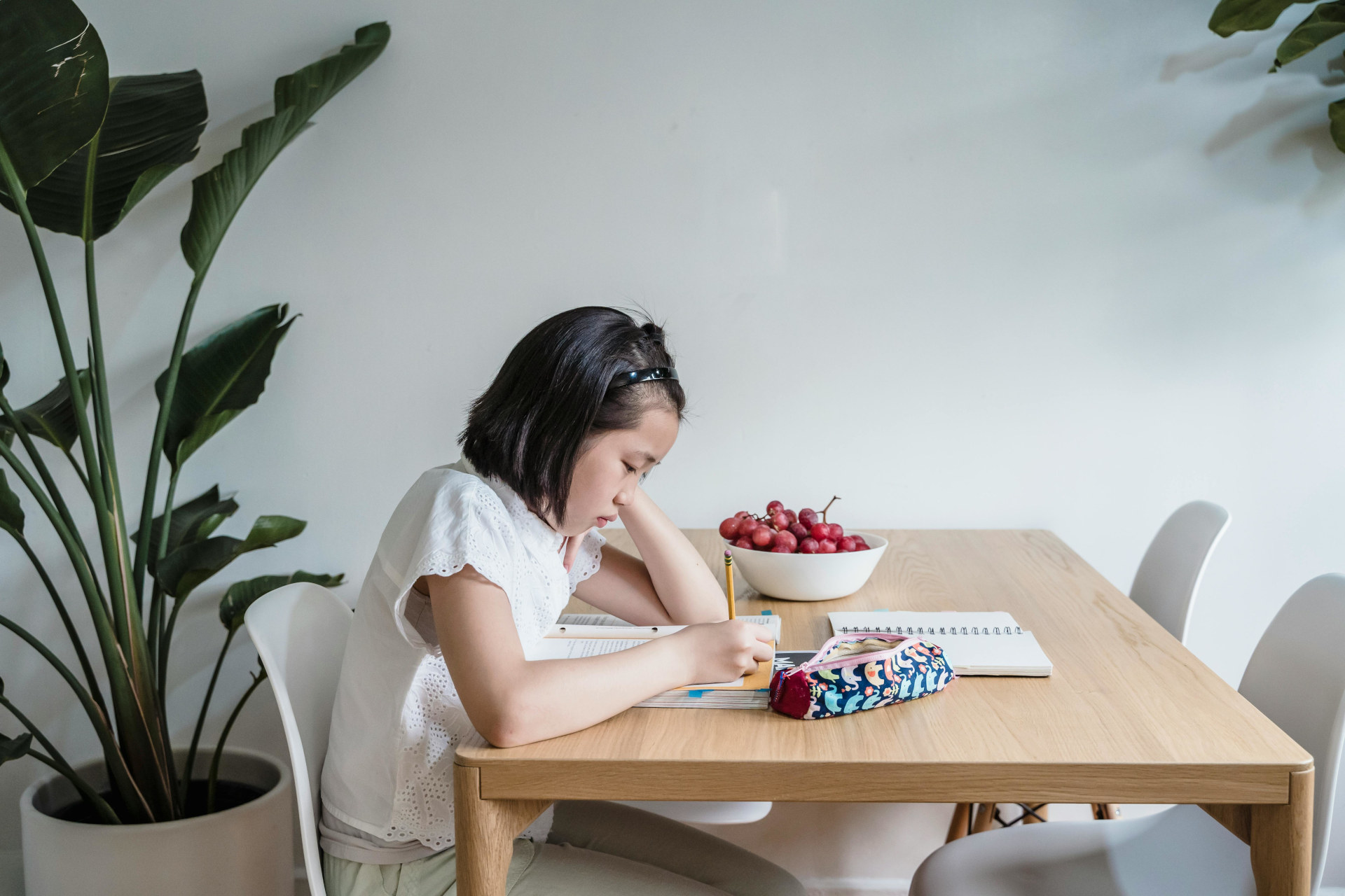 young girl studying at a table